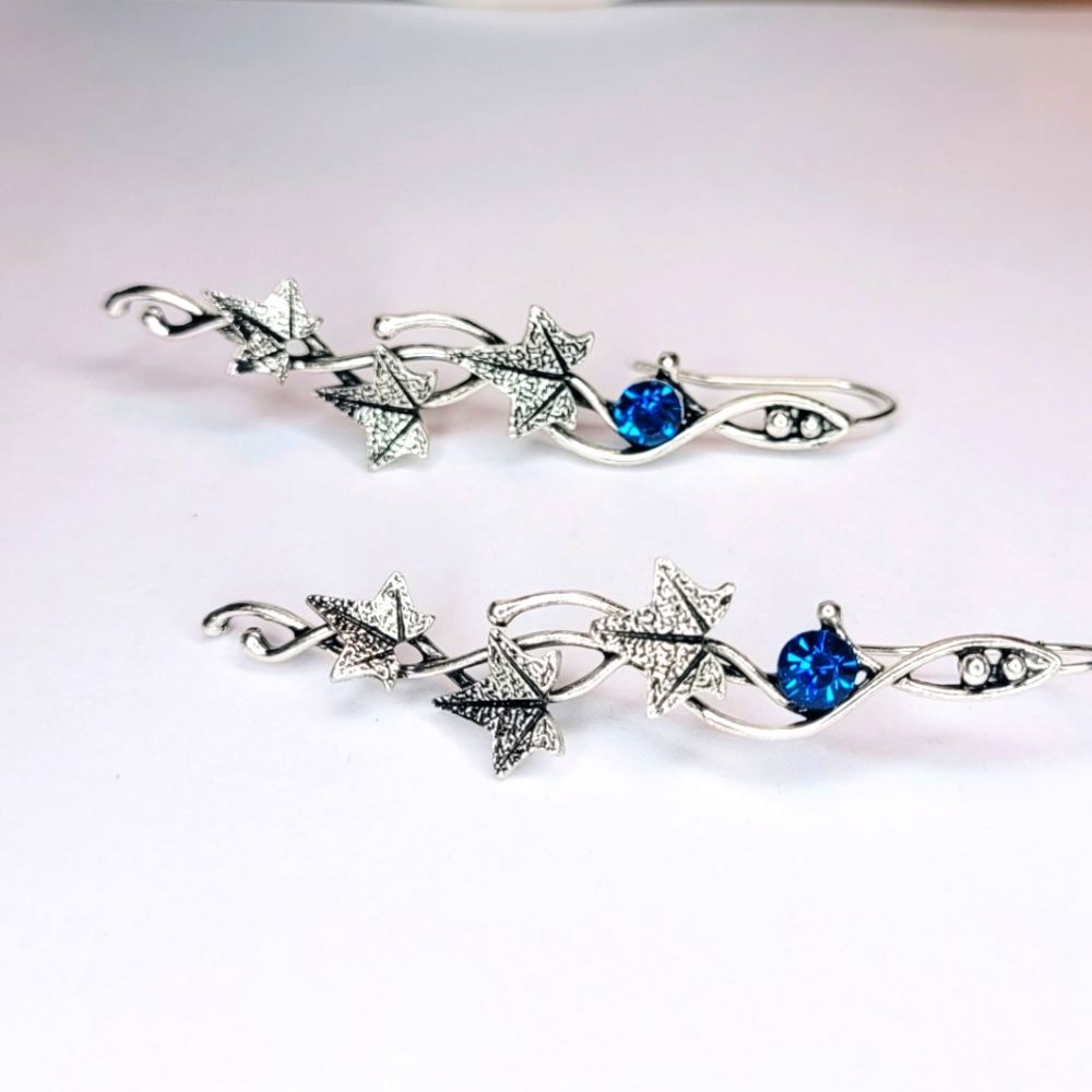 Beautiful leaf shaped silver color vintage style earrings with blue crystal. New